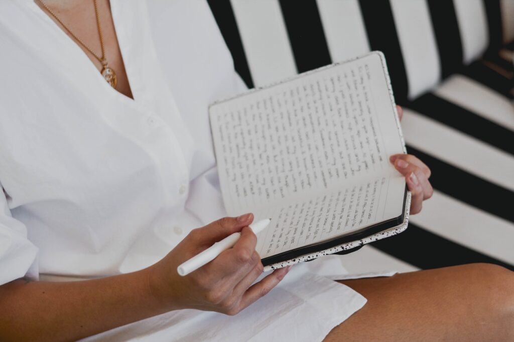 women writing in her journal. 